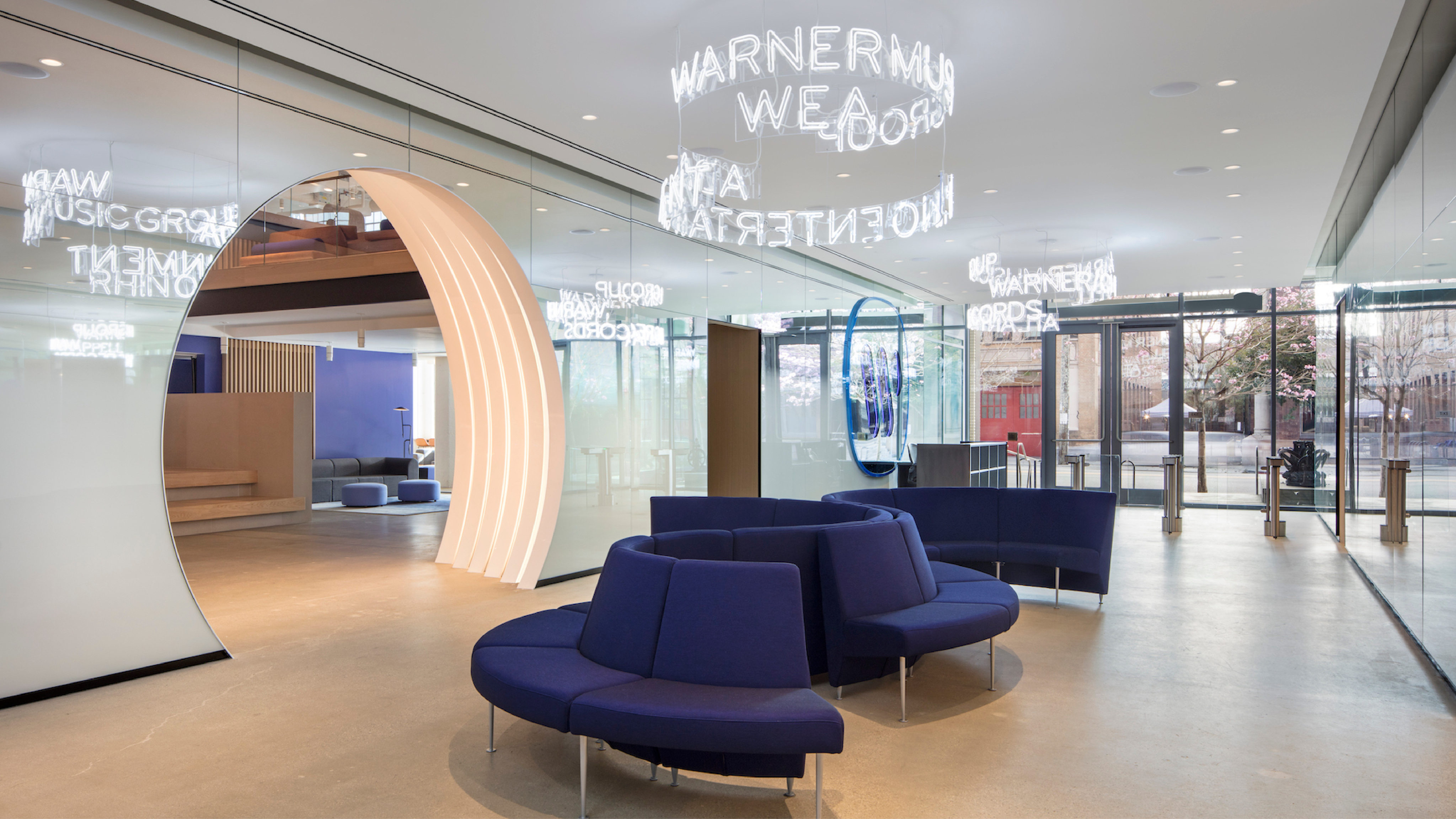 Woman in a suit, holding a flower, bathed in warm light