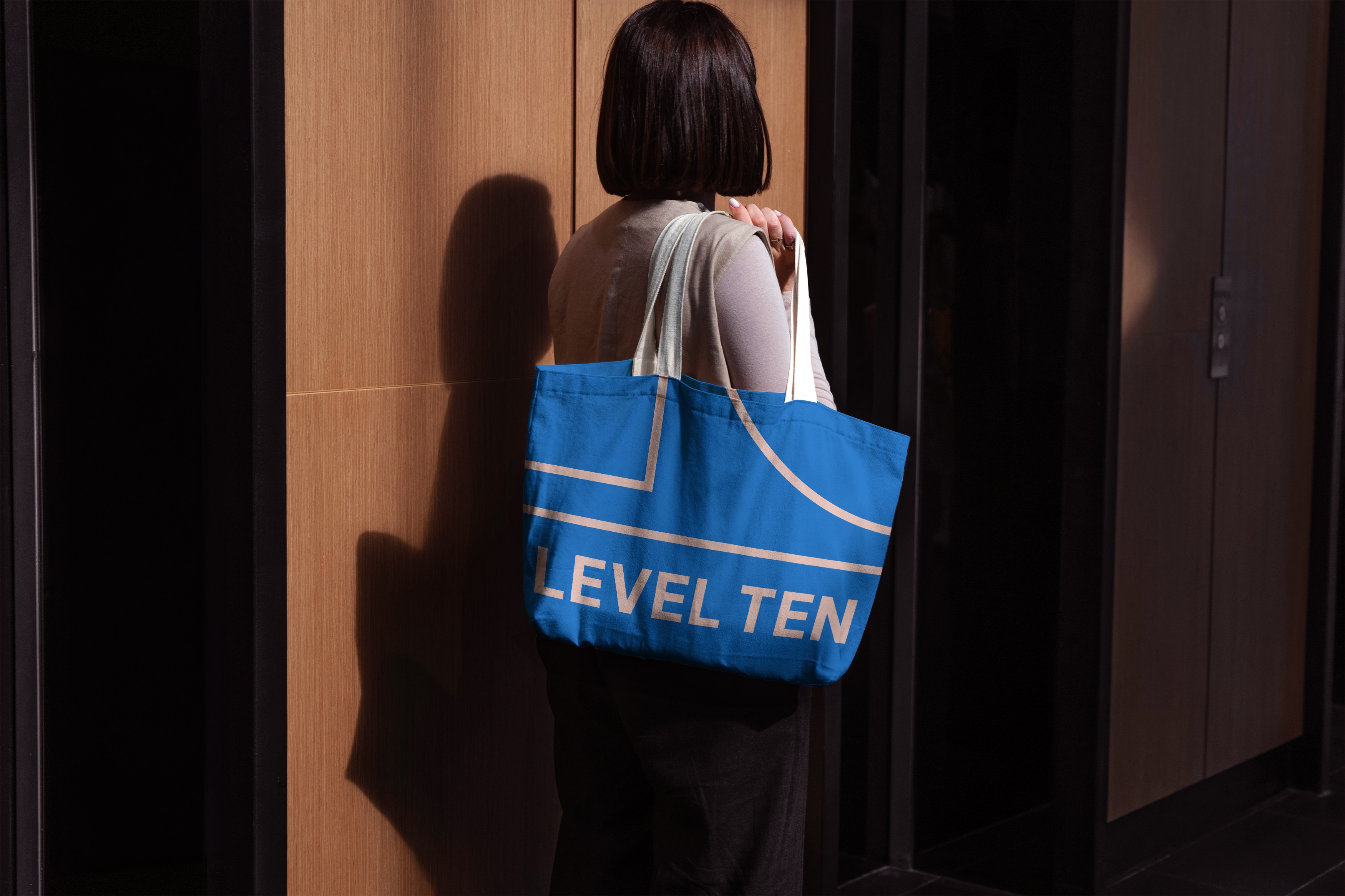 Woman in a suit, holding a flower, bathed in warm light