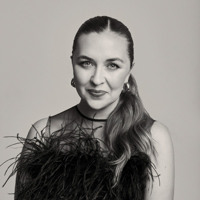 Woman looking to the side covered in a dark veil 